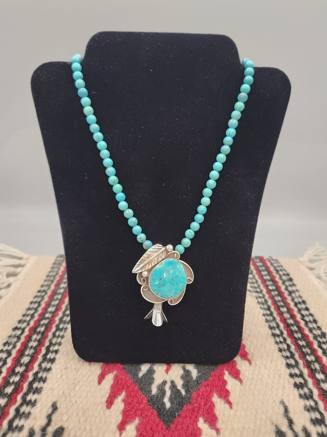 TURQUOISE SQUASH BLOSSOM PENDANT ON TURQUOISE BEADS