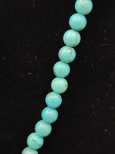 TURQUOISE SQUASH BLOSSOM PENDANT ON TURQUOISE BEADS